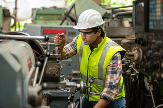 Engineers operating a cnc machine in factory