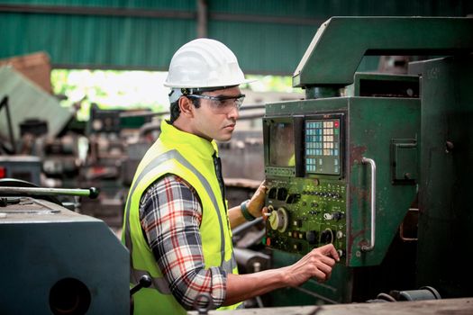 Engineers operating a cnc machine in factory