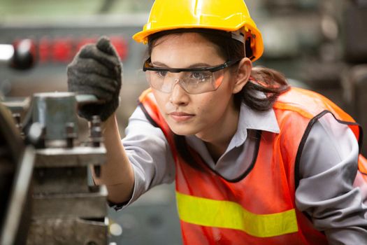 Female Engineers operating a cnc machine in factory