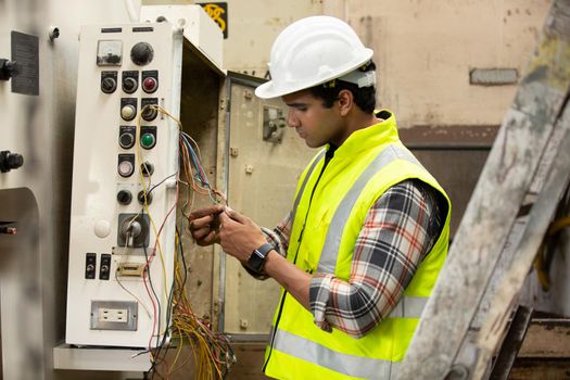 Engineers operating a cnc machine in factory