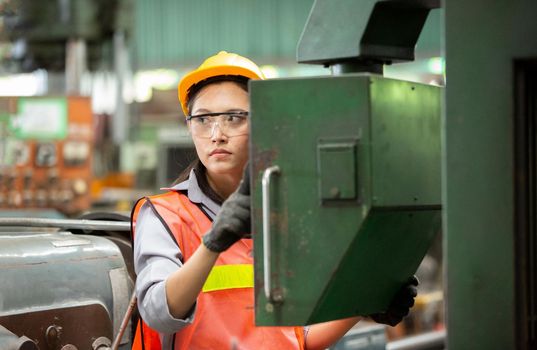 Female Engineers operating a cnc machine in factory