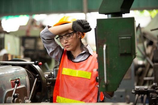 Female Engineers operating a cnc machine in factory