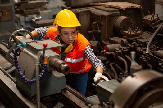 Female Engineers operating a cnc machine in factory