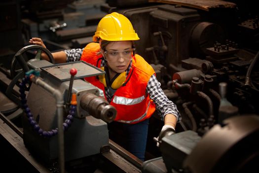 Female Engineers operating a cnc machine in factory