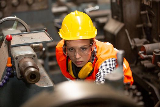 Female Engineers operating a cnc machine in factory