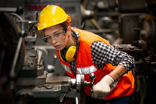 Female Engineers operating a cnc machine in factory