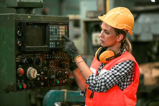 Female Engineers operating a cnc machine in factory