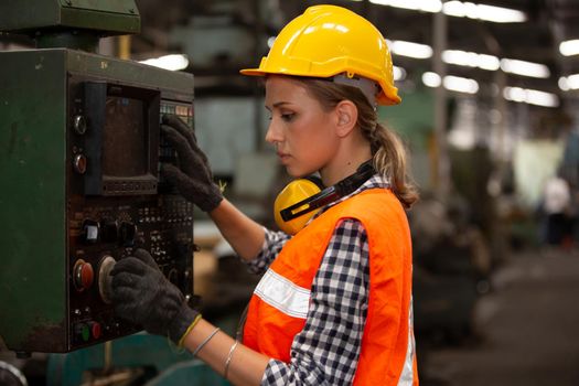 Female Engineers operating a cnc machine in factory