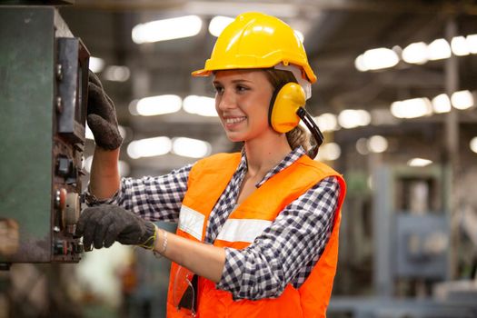 Female Engineers operating a cnc machine in factory