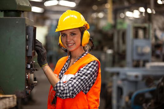 Female Engineers operating a cnc machine in factory