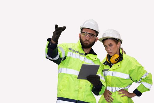 Men and female workers in factory operating machine in workshop floor.	
