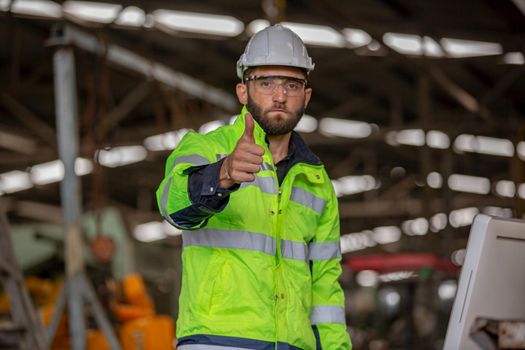 Portrait of female Engineer standing with confident against machine environment in factory, Engineers operating a machine in factory