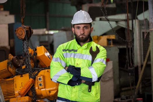 Portrait of male Engineer standing with confident against machine environment in factory, Engineers operating a machine in factory