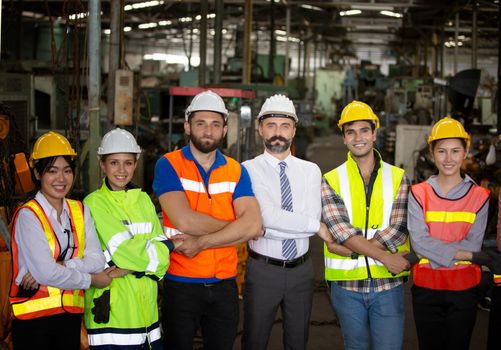 Male Industrial Engineers Talk with Factory Worker . They Work at the Heavy Industry Manufacturing Facility.