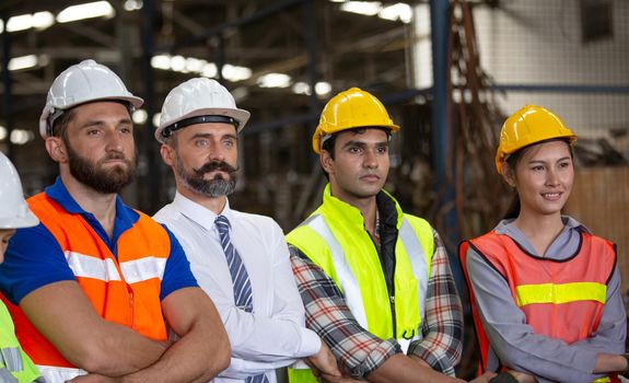 Male Industrial Engineers Talk with Factory Worker . They Work at the Heavy Industry Manufacturing Facility.