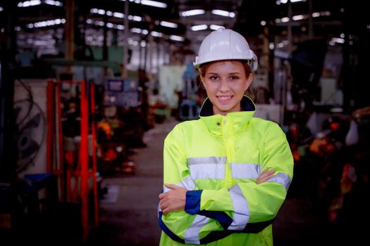 Portrait of female Engineer standing with confident against machine environment in factory