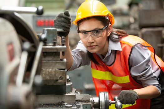 Female Engineers operating a cnc machine in factory