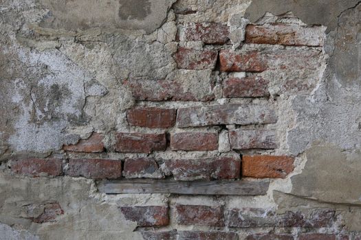 abstract part of the old brick wall with ruined plaster for vintage background and wallpaper in the style of sepia