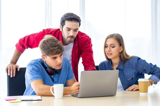 Business people working in office on desktop computer, Group of happy business people in smart casual wear looking at the laptop and gesturing. Achieving success.