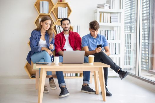 Business people working in office on desktop computer, Group of happy business people in smart casual wear looking at the laptop and gesturing. Achieving success.