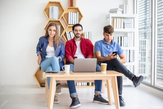 Business people working in office on desktop computer, Group of happy business people in smart casual wear looking at the laptop and gesturing. Achieving success.