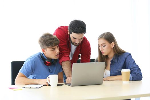 Business people working in office on desktop computer, Group of happy business people in smart casual wear looking at the laptop and gesturing. Achieving success.