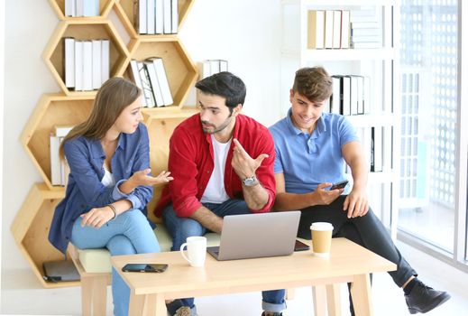 Business people working in office on desktop computer, Group of happy business people in smart casual wear looking at the laptop and gesturing. Achieving success.