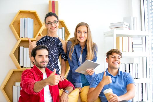 Business people working in office on desktop computer, Group of happy business people in smart casual wear looking at the laptop and gesturing. Achieving success.