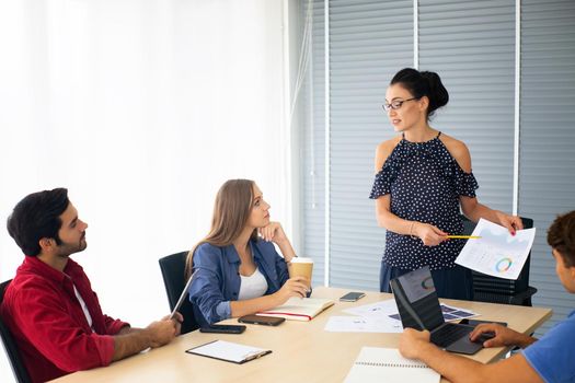 Business people working in office on desktop computer, Group of happy business people in smart casual wear looking at the laptop and gesturing. Achieving success.