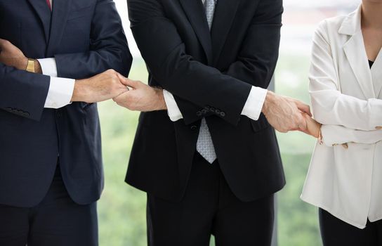 Business people give hands stack or holding each other for Unity and teamwork concept.	