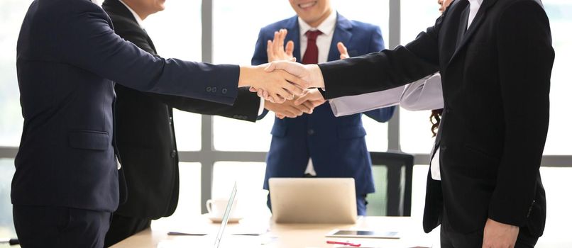 Business people shaking hands in the modern office finishing successful meeting