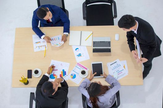 Top view on a group of businessman and businesswoman having a meeting and making a business commitment.