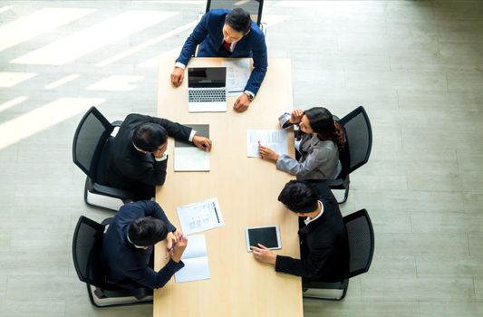 Top view on a group of businessman and businesswoman having a meeting and making a business commitment.