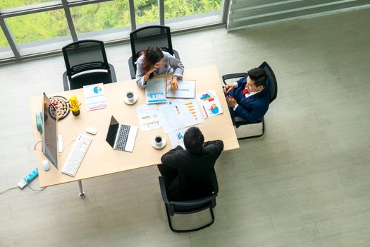 Top view on a group of businessman and businesswoman having a meeting and making a business commitment.