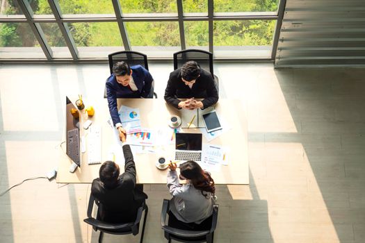 Top view on a group of businessman and businesswoman having a meeting and making a business commitment.