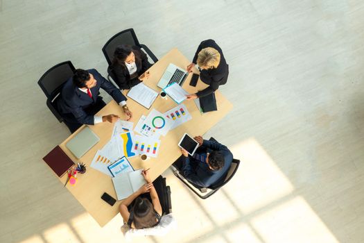 Top view on a group of businessman and businesswoman having a meeting and making a business commitment.