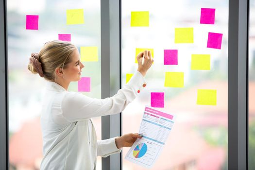 young business team working together at office. Manager pointing at a chart and explaining the analysis about business strategies. Top view shot of business hand shake