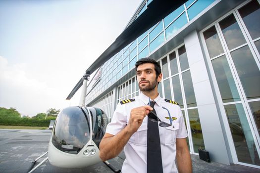 Shot of a mature Helicopter pilot using a headset while traveling in a helicopter, Business people traveling by helicopter