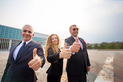 confident business people standing against his private helicopter at landing airport. Professional career success concept	