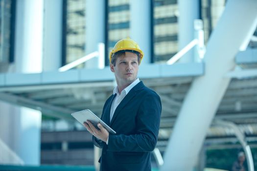 The engineer and business people hand high five against building. The concept of engineering, construction, city life and future.