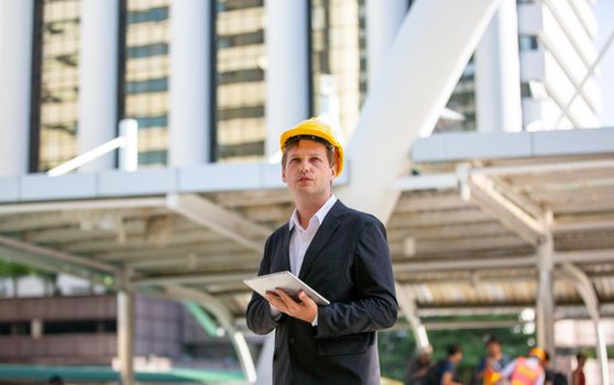 The engineer and business people hand high five against building. The concept of engineering, construction, city life and future.