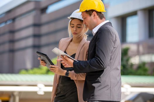 Engineering civil, Construction engineers discussion with architects at construction site or building site of high-rise building with Surveying for making contour plans