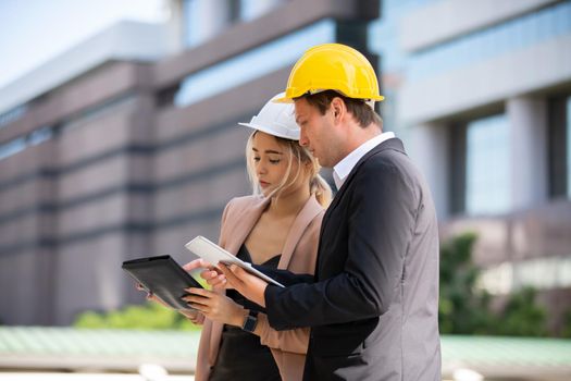 Engineering civil, Construction engineers discussion with architects at construction site or building site of high-rise building with Surveying for making contour plans