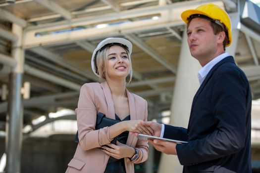 Engineering civil, Construction engineers discussion with architects at construction site or building site of high-rise building with Surveying for making contour plans