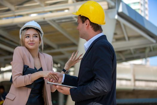 Engineering civil, Construction engineers discussion with architects at construction site or building site of high-rise building with Surveying for making contour plans