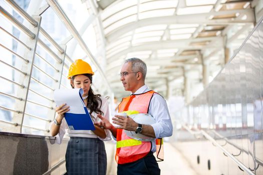 The engineer and business people hand high five against building. The concept of engineering, construction, city life and future.