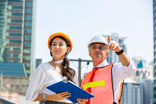 The engineer and business people hand high five against building. The concept of engineering, construction, city life and future.