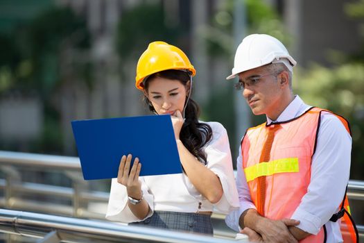 The engineer and business people hand high five against building. The concept of engineering, construction, city life and future.