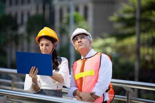 The engineer and business people hand high five against building. The concept of engineering, construction, city life and future.