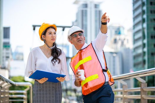 The engineer and business people hand high five against building. The concept of engineering, construction, city life and future.